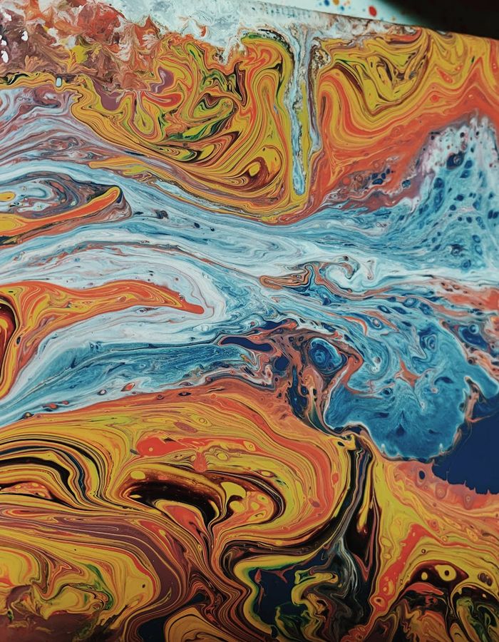 Abstract orange and dark shapes representing fluid motion